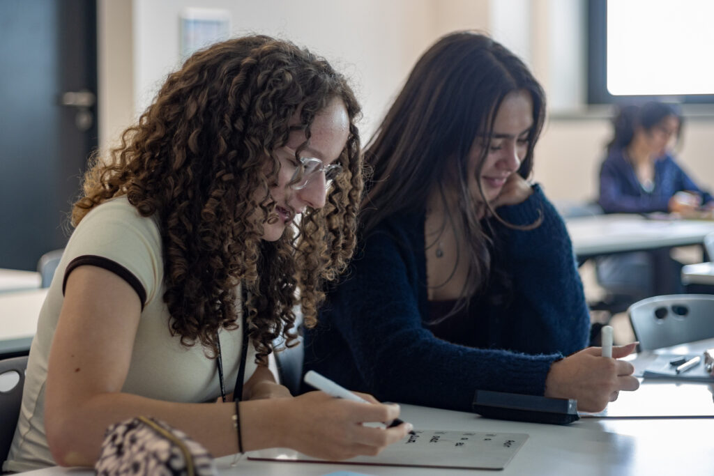 A Level French lesson in St David's Catholic Sixth Form College with two students writing notes