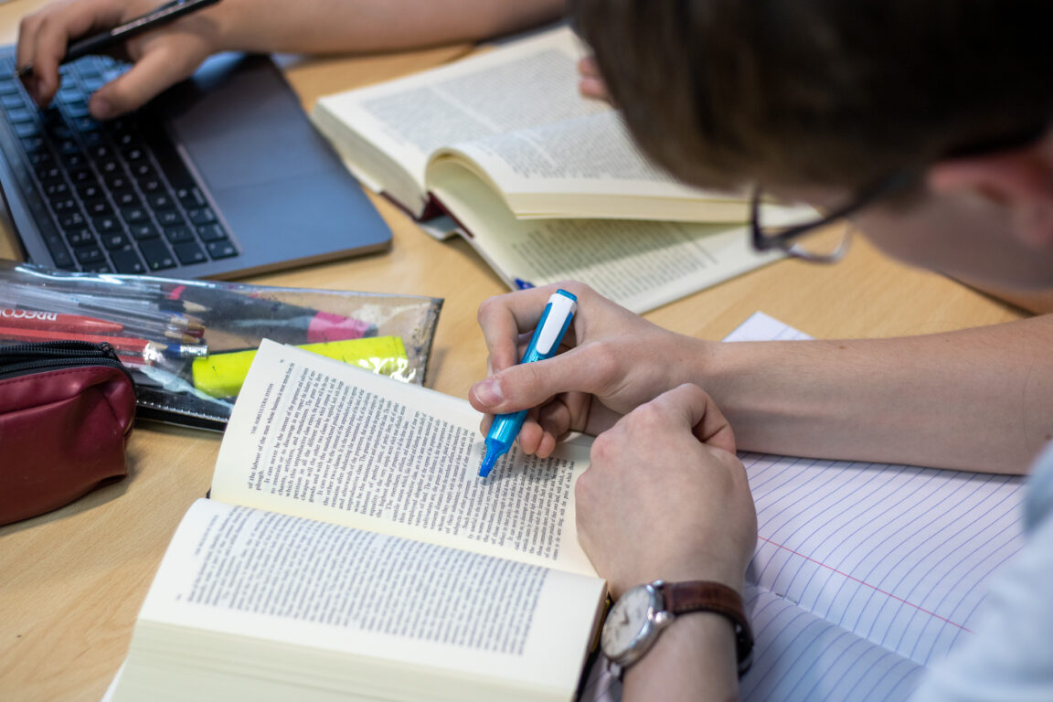 St David's College student using a book and highlighter seeking exam support