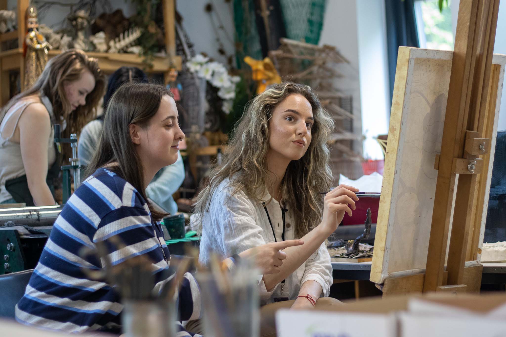 Applications Hub - Image of students painting on canvas occupying apply page for St David's Catholic Sixth Form College
