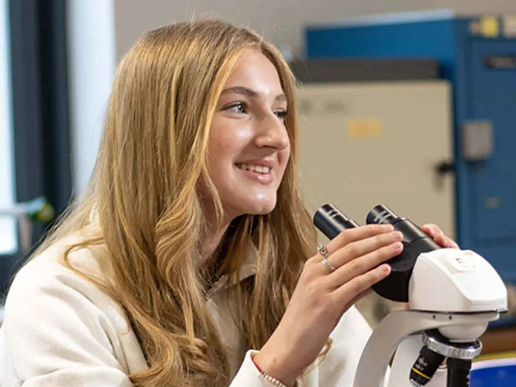 Home of St David's College - Student looking through microscope
