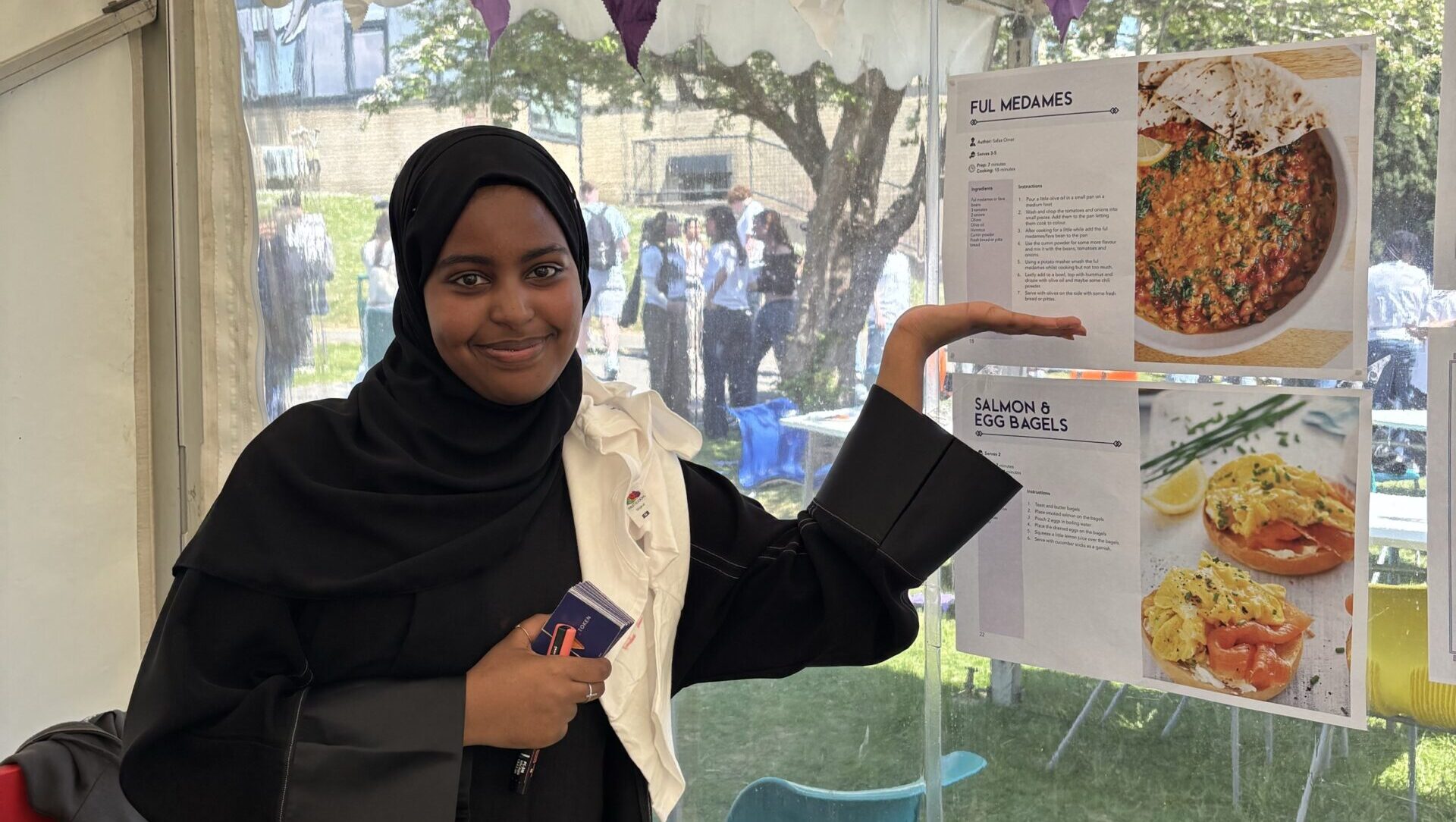 Learner pointing towards one of her recipes included with recipes for success