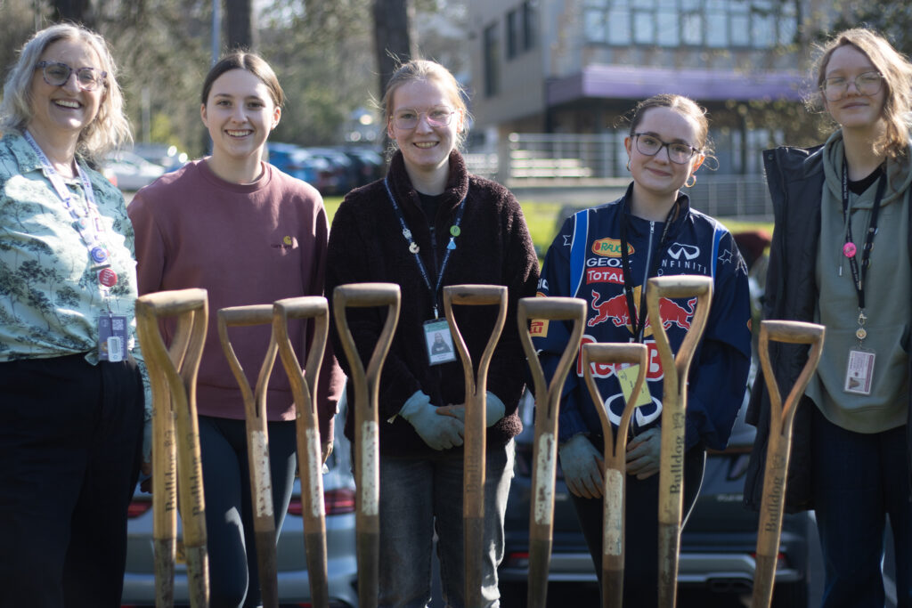Students behind shovels