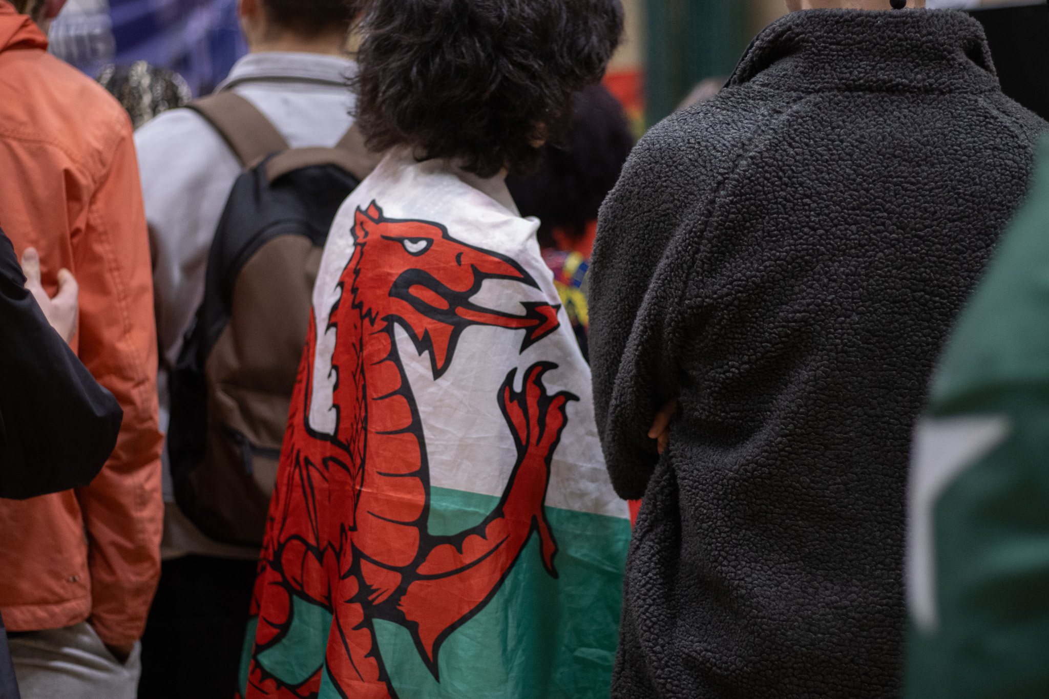student with a welsh flag on their back