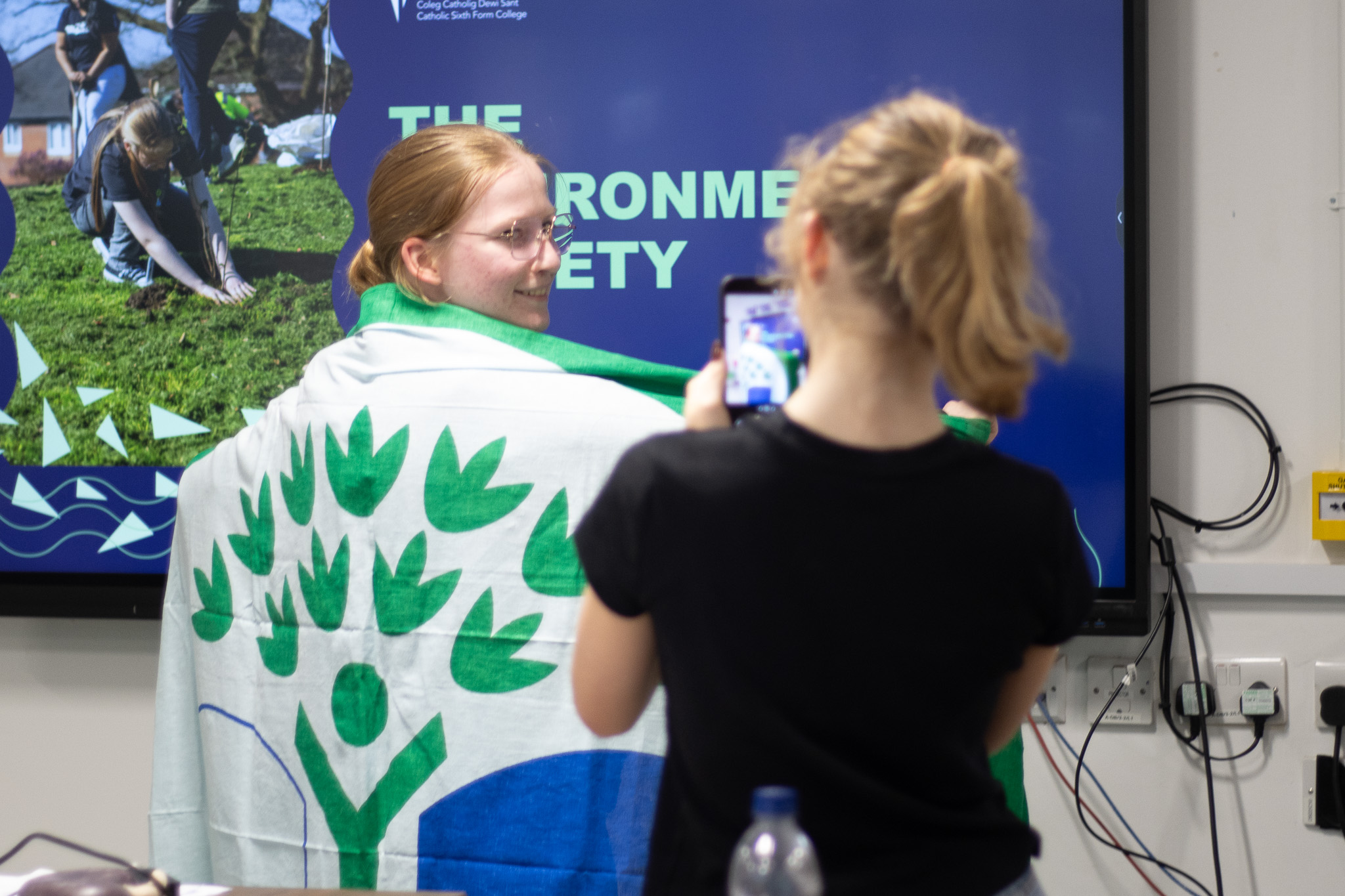 Student draped in the Green Flag