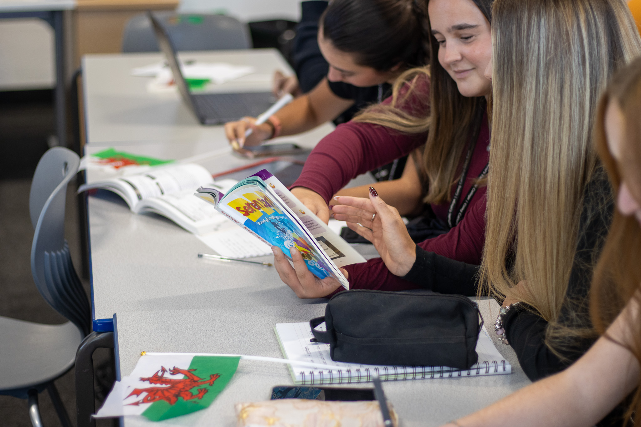 Students studying a Welsh textbook