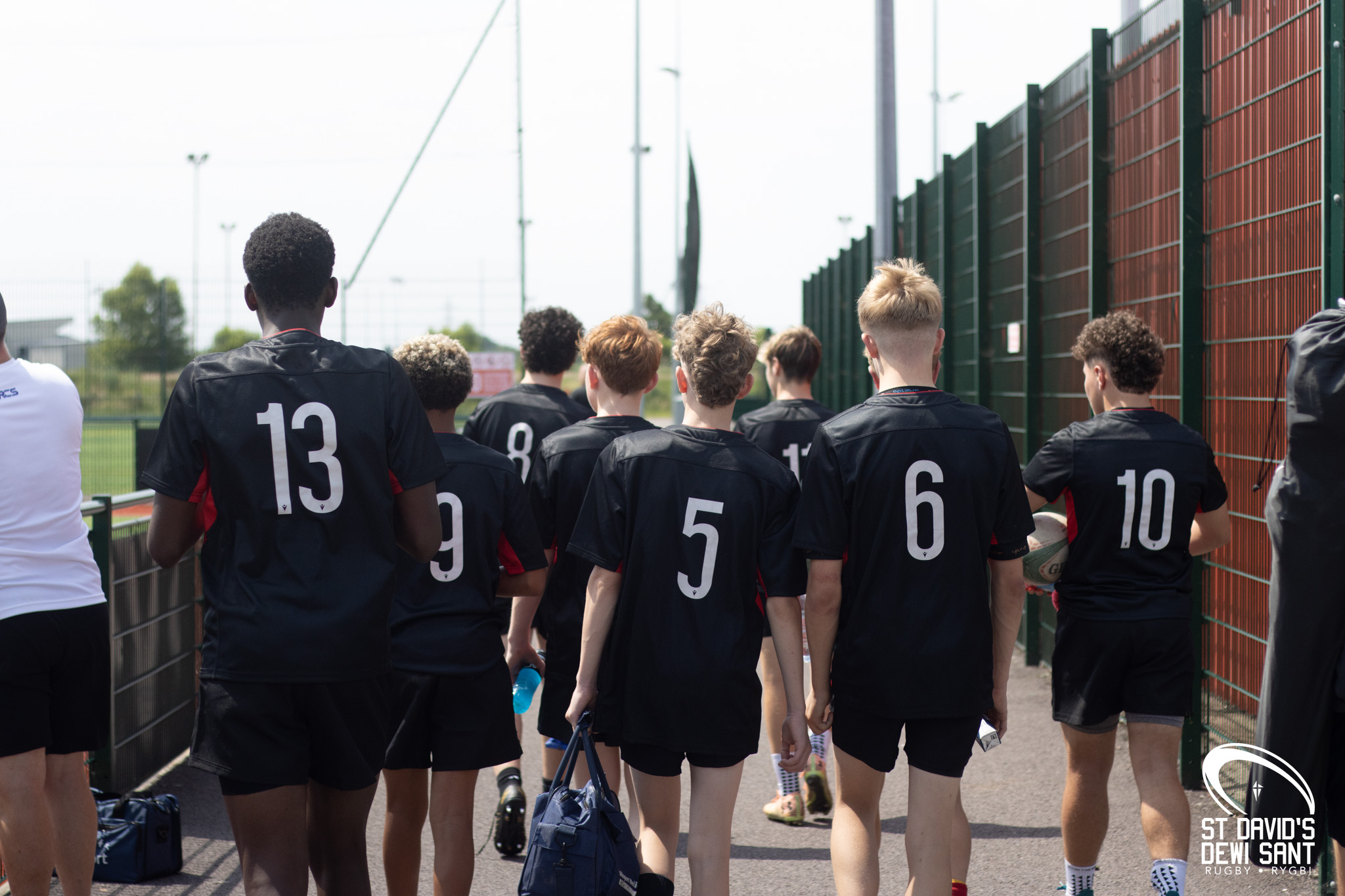 Students walking away from the camera at the St David's Sevens tournament
