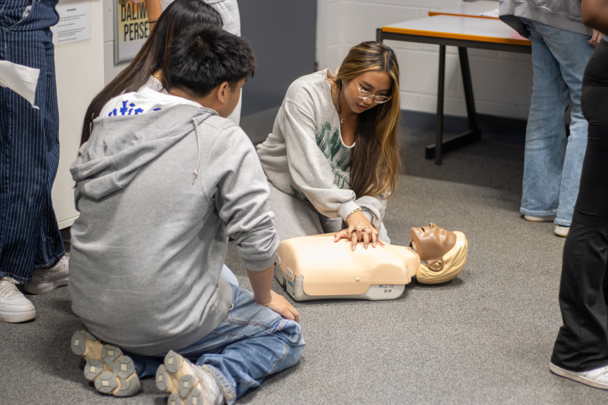 Students practicing first aid on a dummy