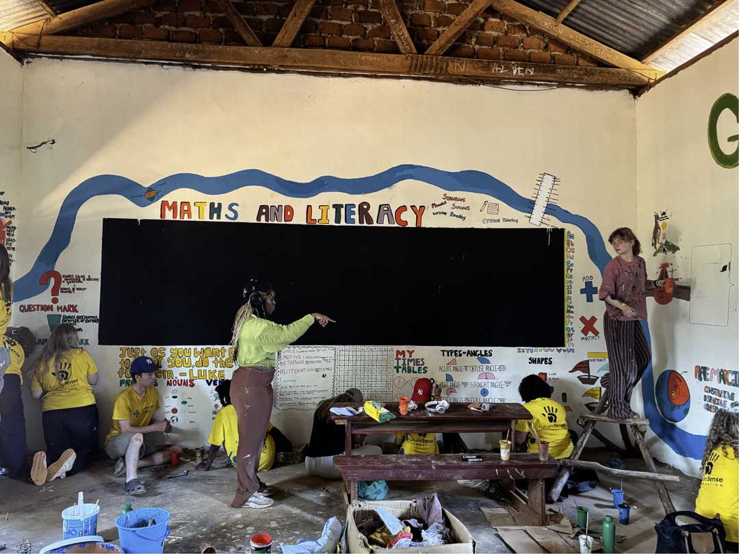 Students painting a classroom wall