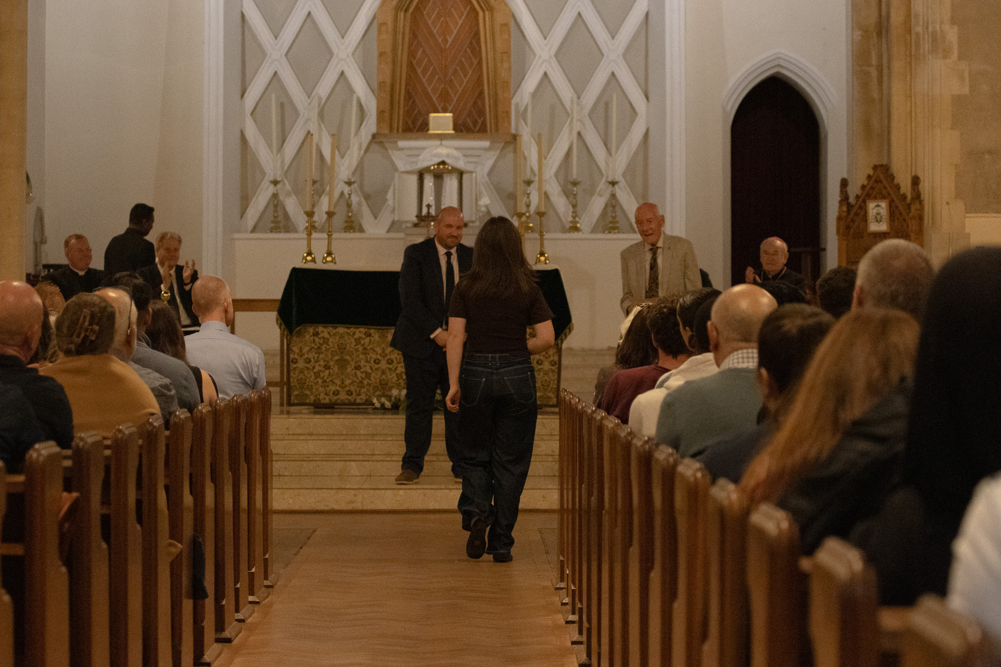 St David's class of 2026 student walking down cathedral aisle for award