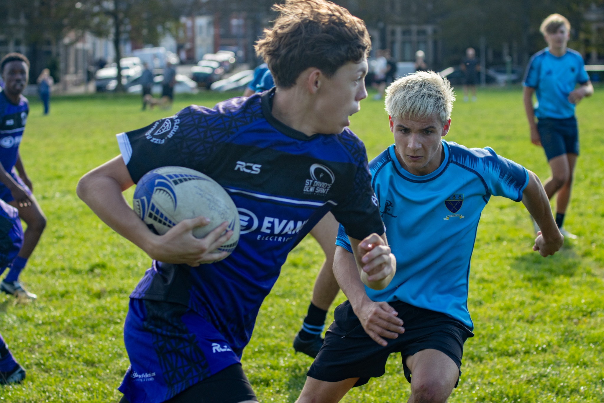 St David's College student running with rugby ball