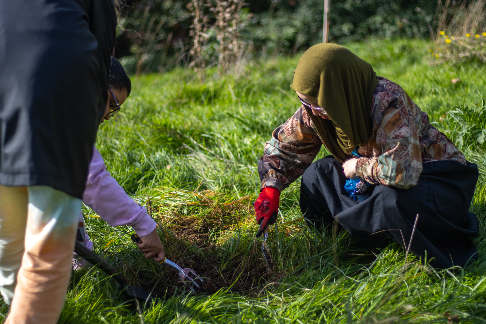 member of St David's College Environmental Society planting bulbs.
